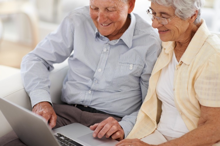 Senior couple working on laptop