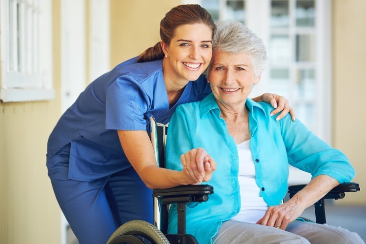 Team member with woman in wheel chair