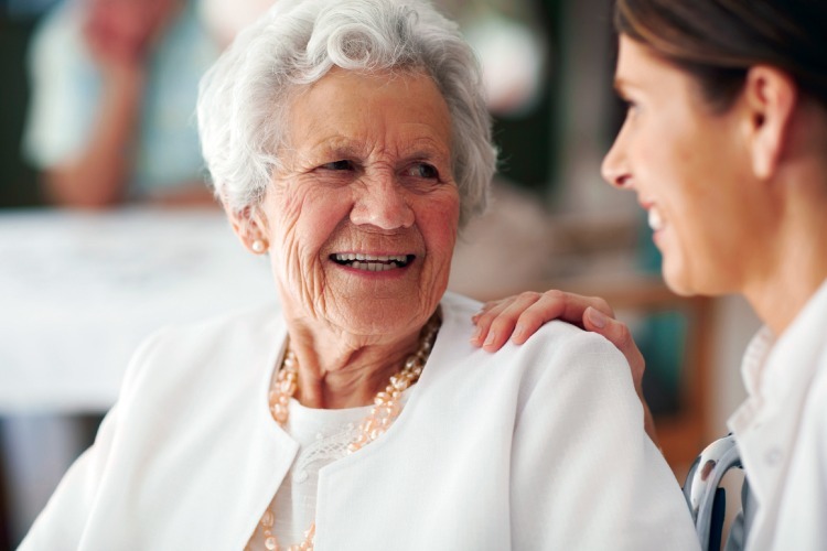 Memory Care Staff member smiling at Prairieview member