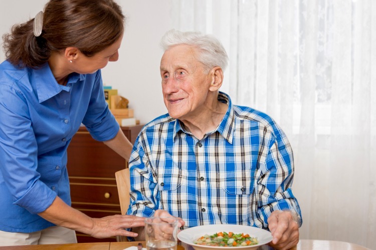 Senior man having a bowl of soup