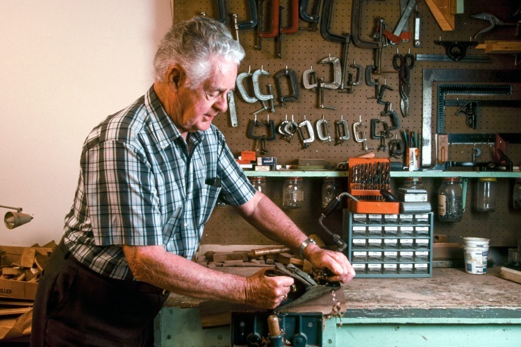 Senior man working in wood shop