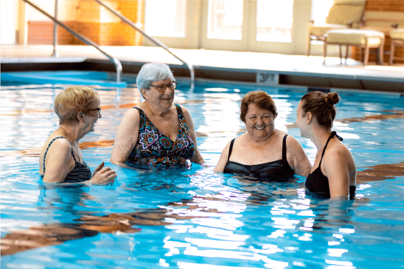 indoor pool members chatting in indoor pool