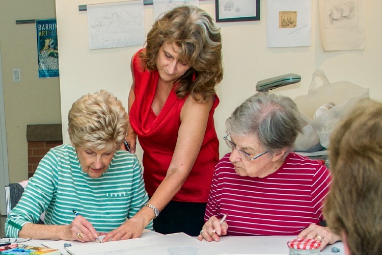 Volunteer helping with art class