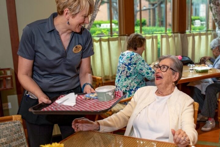 Server bring soup to woman member