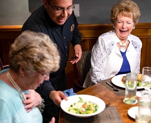 Female member being served salad