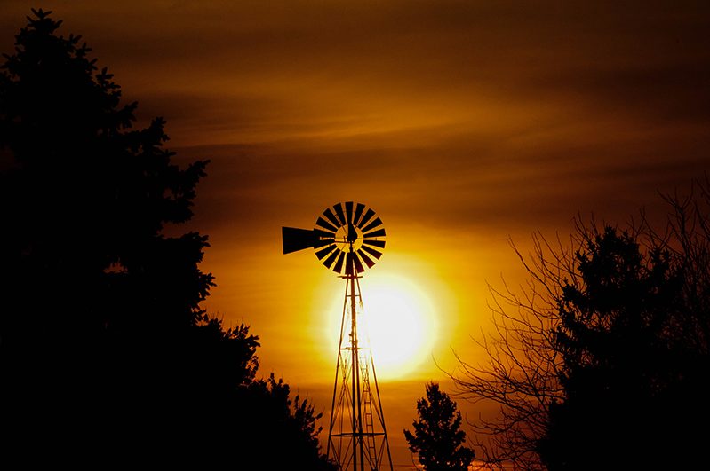 Wind mill agains an orange sunset