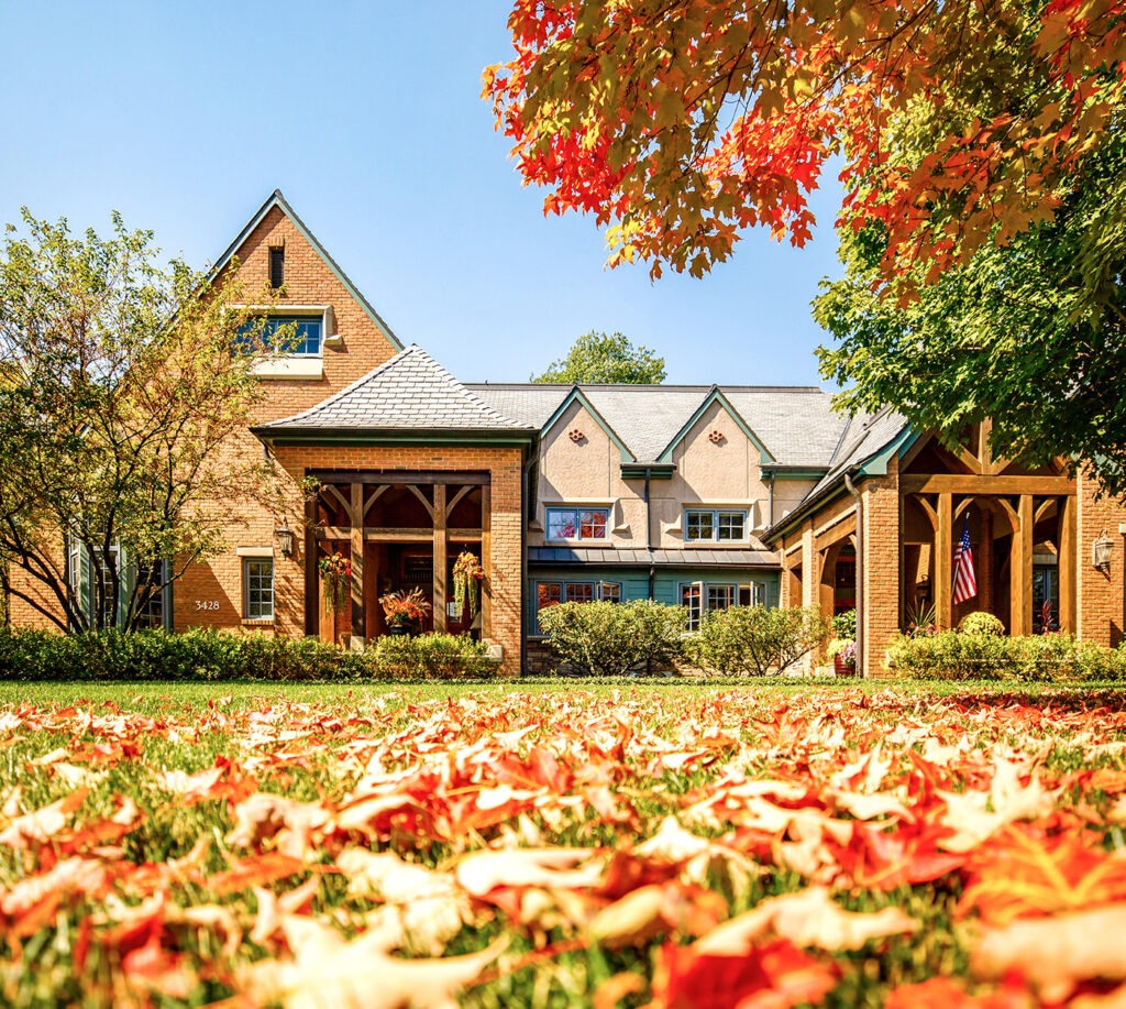 A Garlands Villa with fall leaves on the ground and tree changing colors