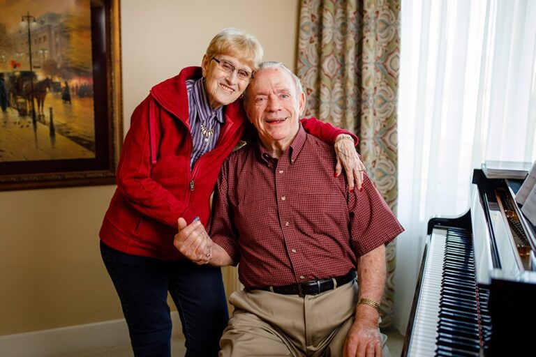Oliver and Barb Mayes near a piano