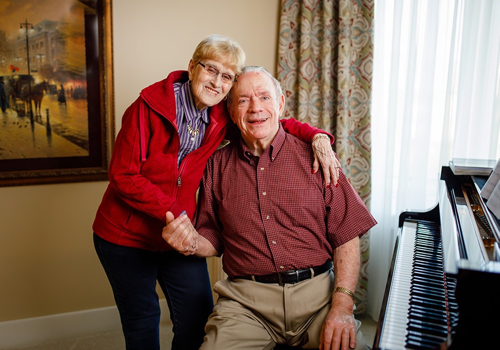 Oliver and Barb Mayes near a piano