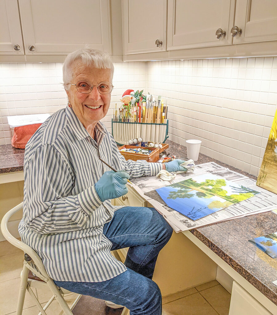 Marlene Peterson painting in her kitchen