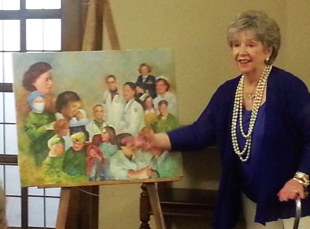 Kathleen L. McCann presenting one of her favorite paintings