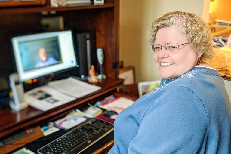 Peggy Clough at her computer