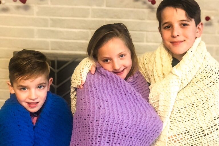 Grandchildren with knitted blankets