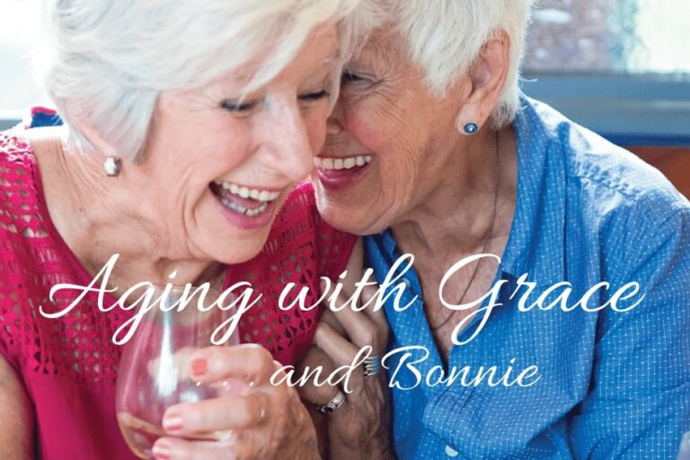 Two woman sharing a glass of wine and laughing together