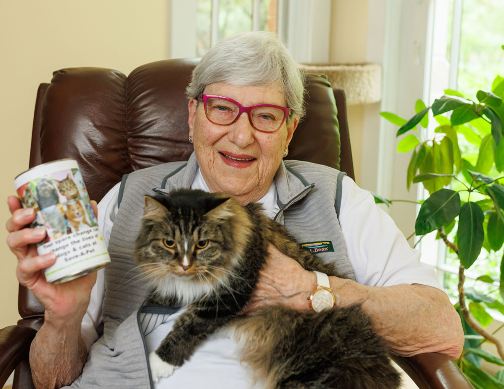 Lee Heckmeck with her cat and donation can