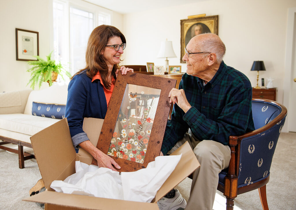 Sarah Parker assists a new member while he unpacks.