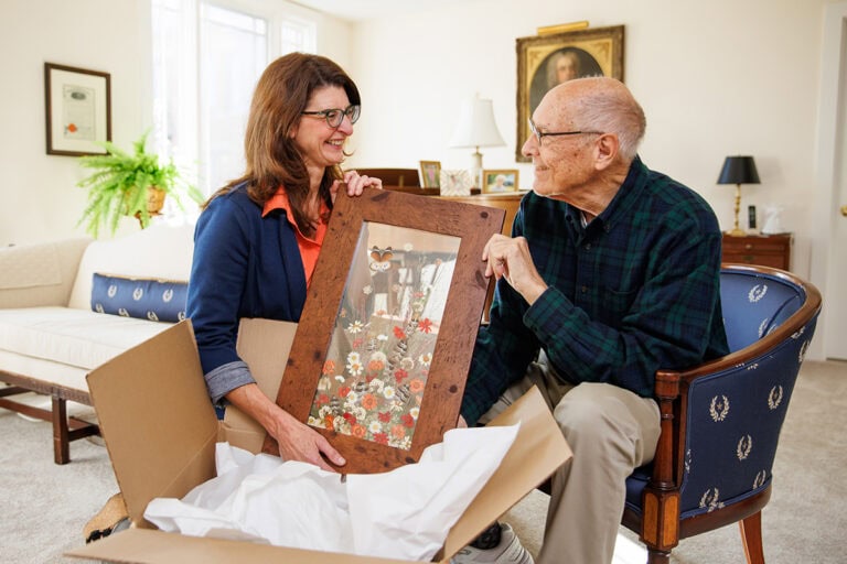 Sarah Parker assists a new member while he unpacks.