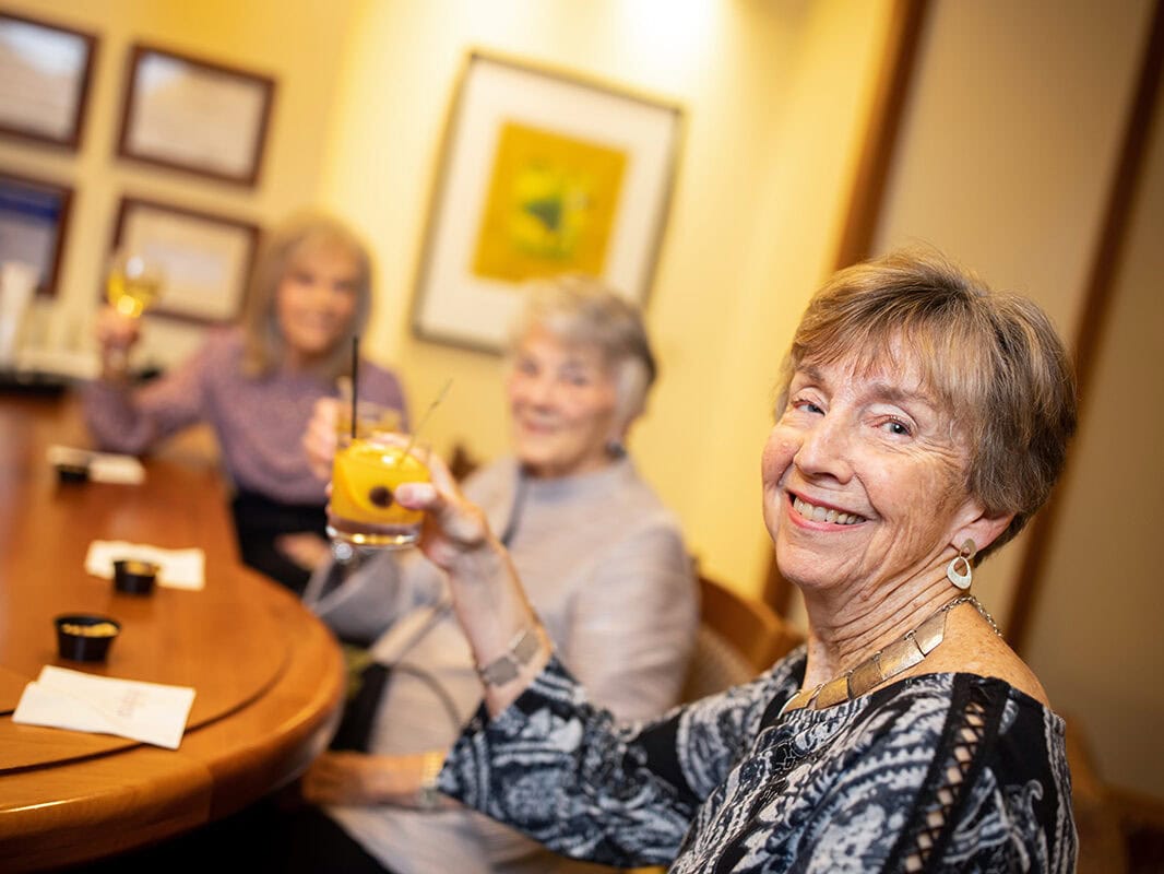 Garlands members toasting at the bar