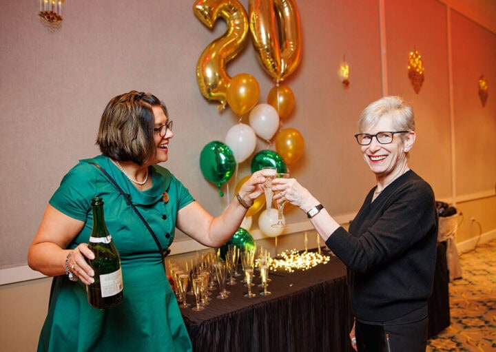 STaff member and resident toasting to 20 years