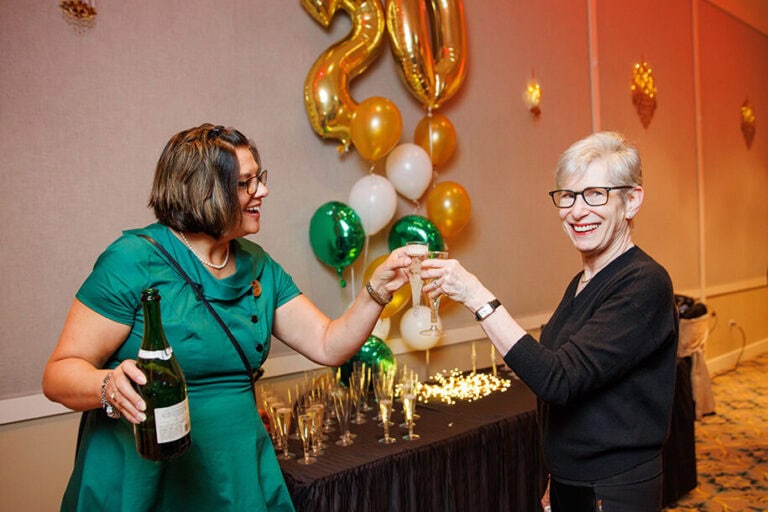 STaff member and resident toasting to 20 years