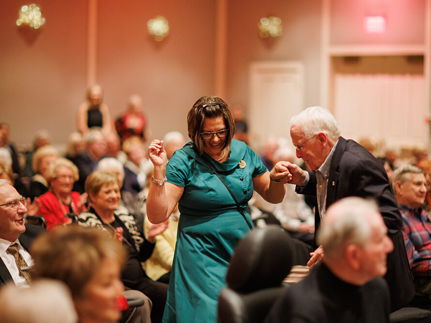 Staff member dancing to live music in the banquet room