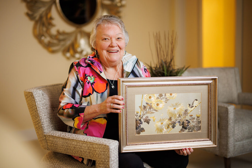 Linda Hughes showing her Chokin Artwork