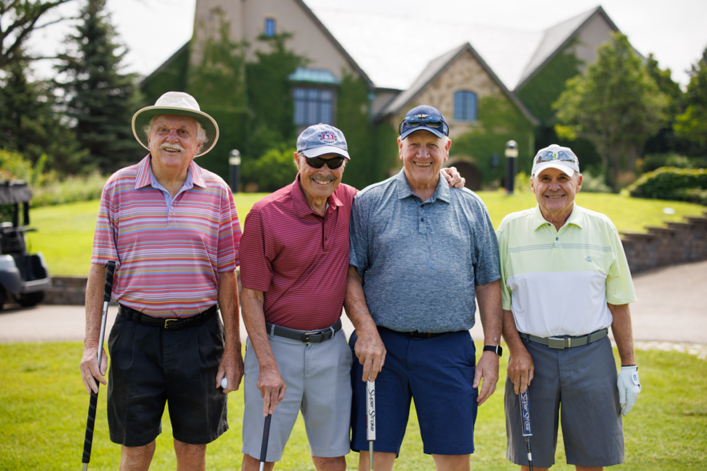 Four Men getting reqady to go golfing