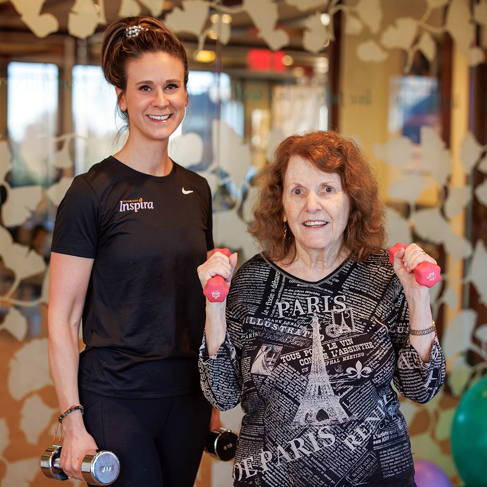 Bethany and a member using free weights