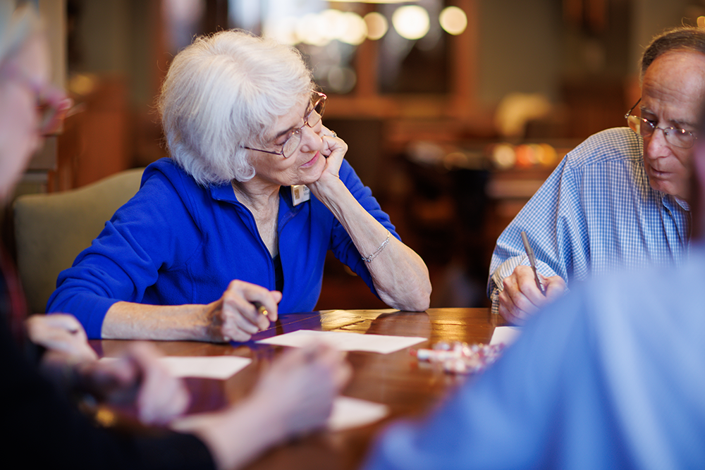 Small Group learning about something new around a table.