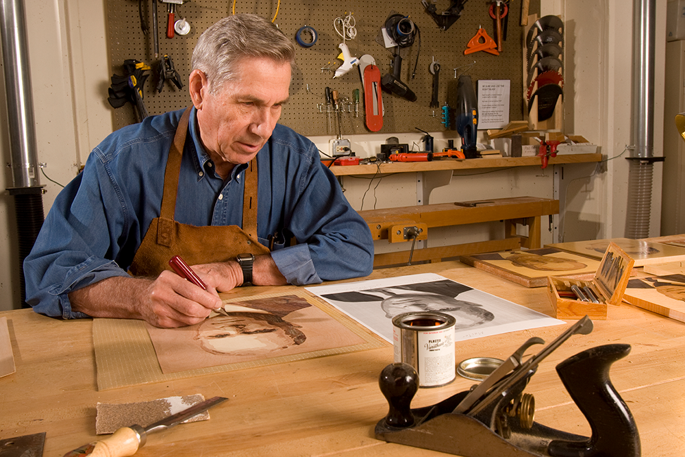 member cutting away art in the wood shop