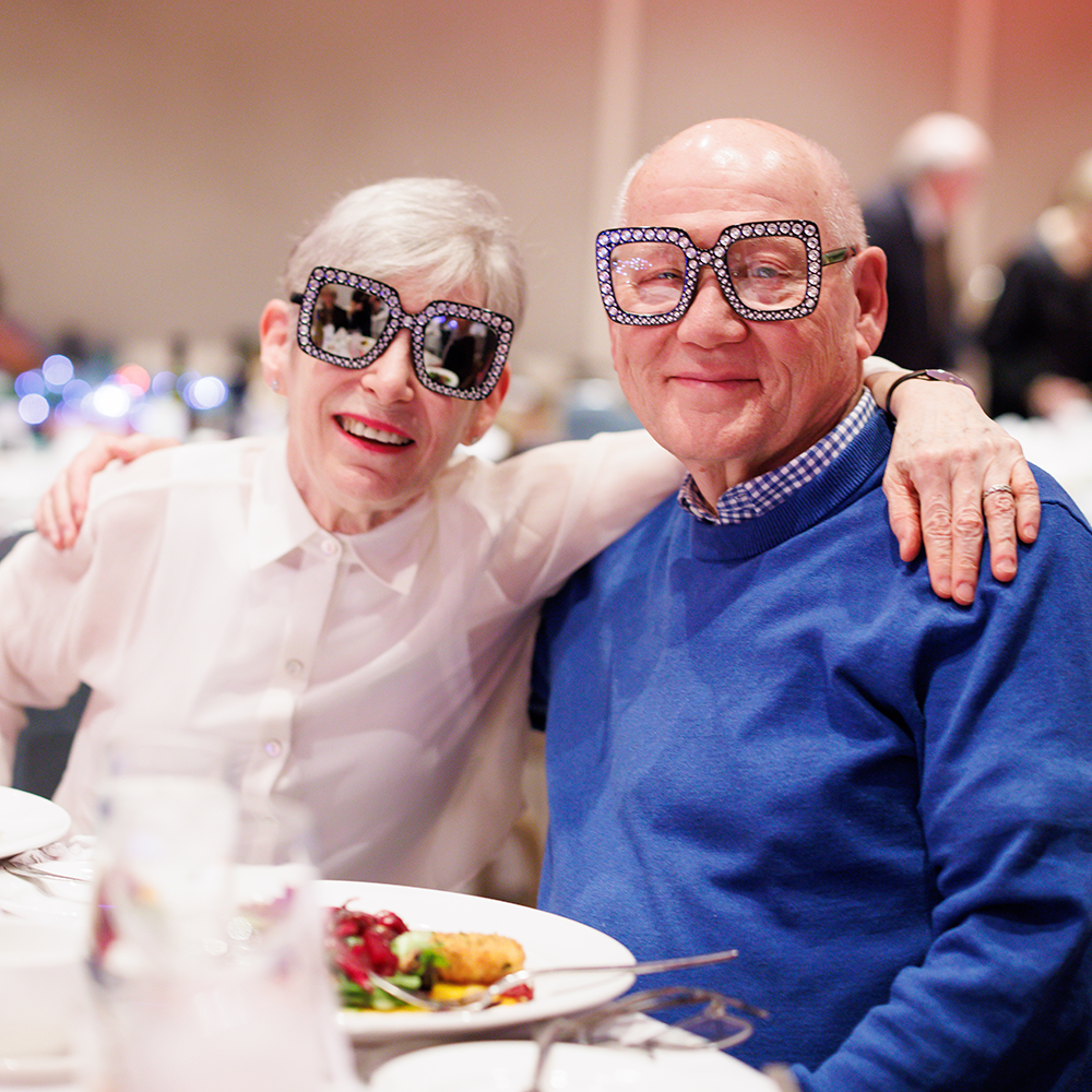 Couple Dining at The Center for Performing Arts with Elton John Glasses on their face.