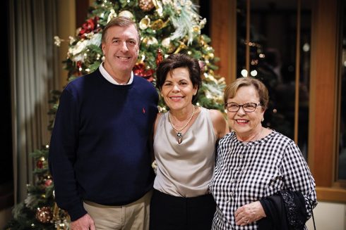 Three friends in front of the Christmas Tree