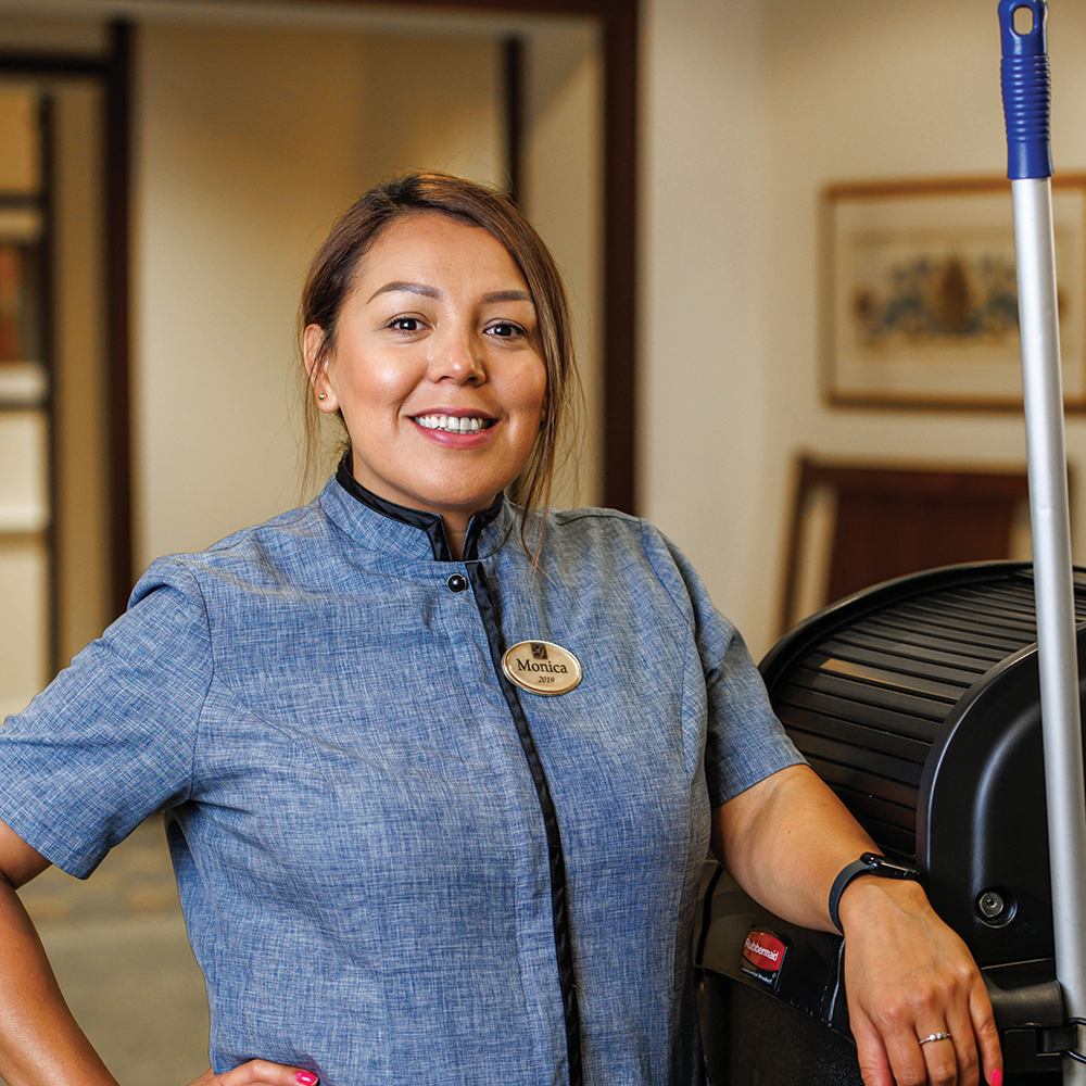 Monica standing next to a cleaning cart