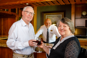 A couple enjoying a glass of red wine.