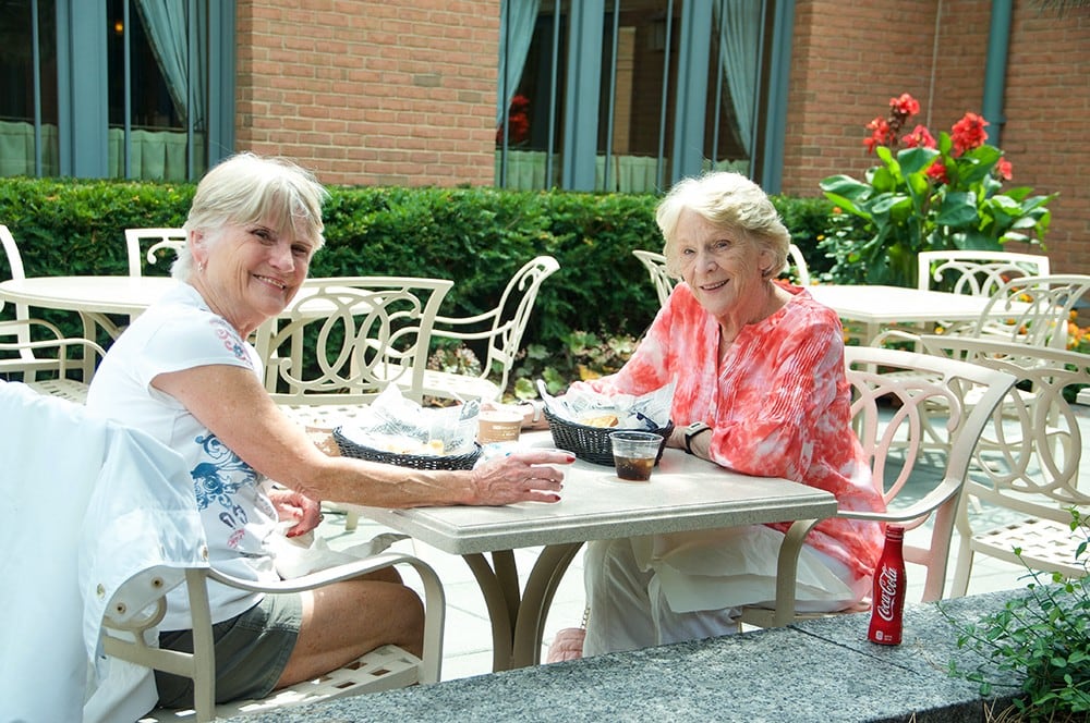 Two friends dining outside
