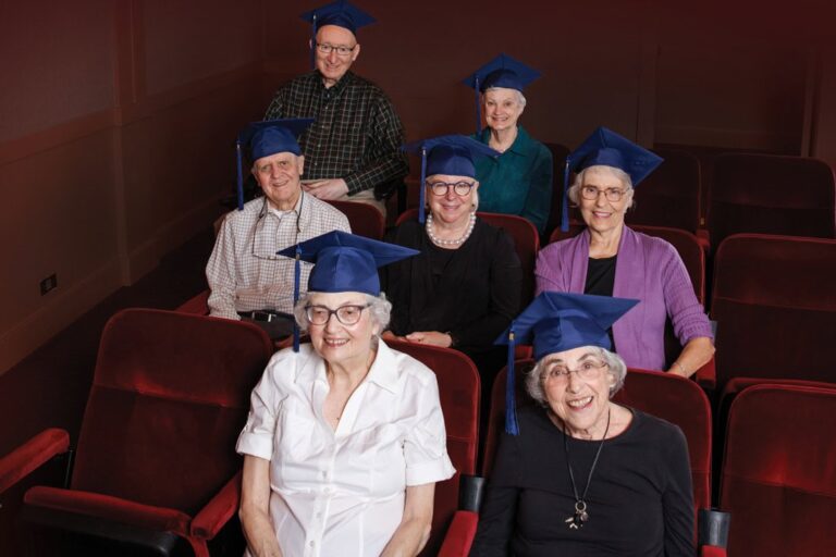 Seniors wearing graduation caps in the theater at The Garlands