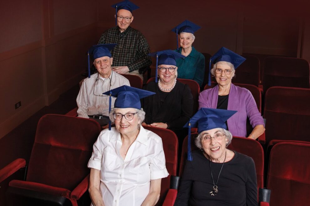Seniors wearing graduation caps in the theater at The Garlands