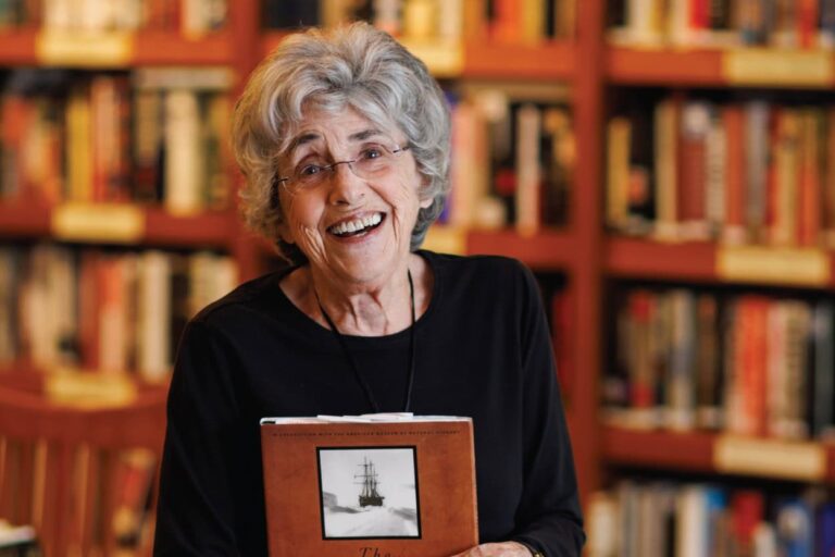 Lanny Ori in the library holding a book