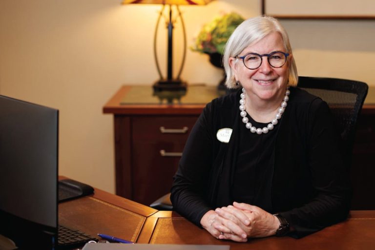 Martha sitting at her concierge desk