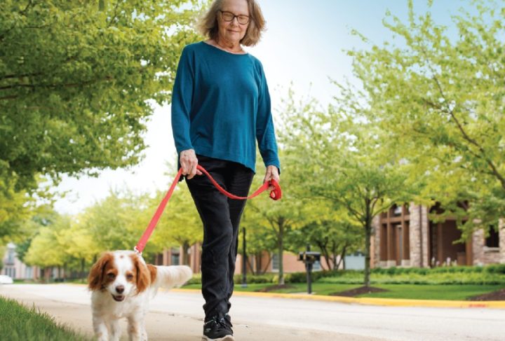woman walking her dog outside at The Garlands