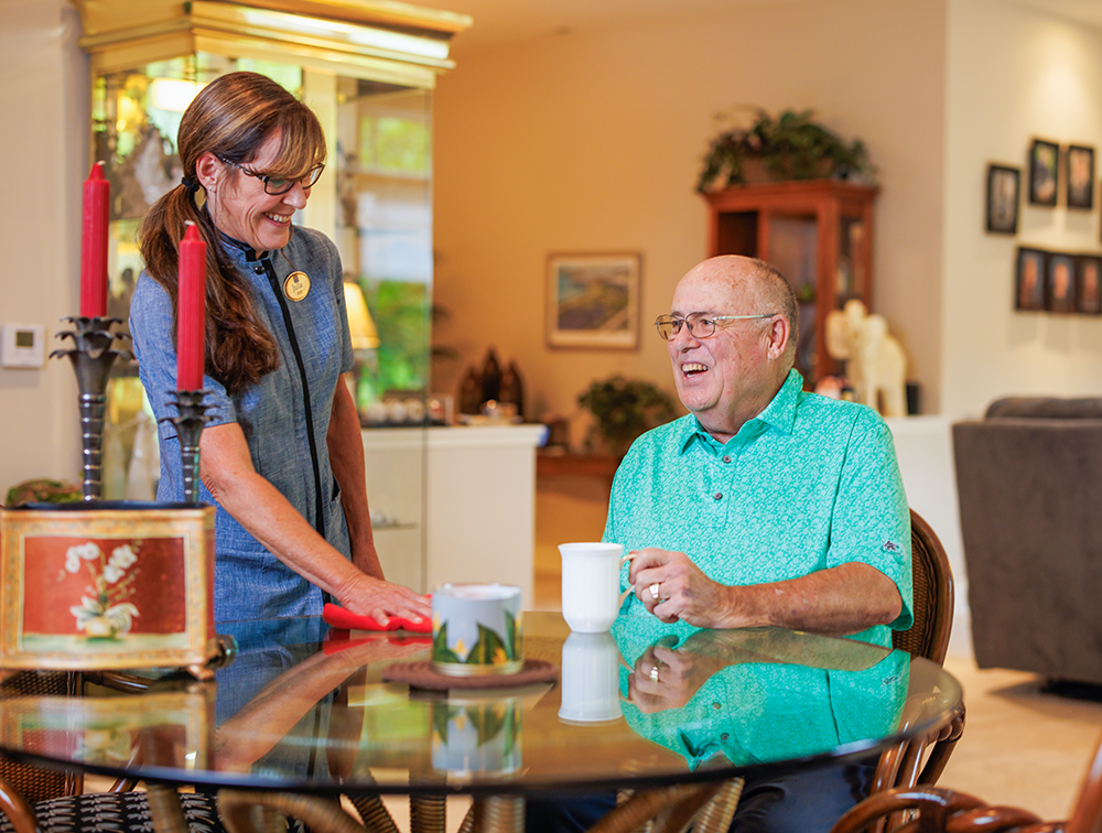 Garlands staff helping a Garlands member in his home.