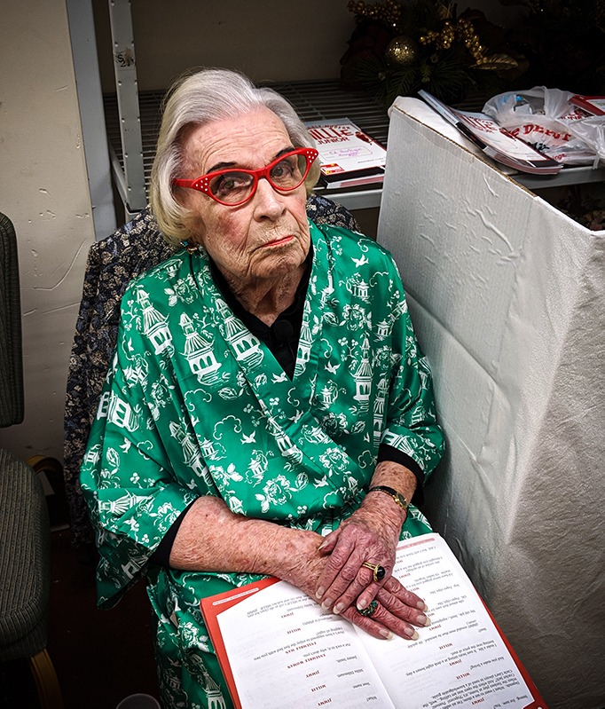 Lee Nelsen as Mrs. Meers resting in back after running the Hotel Priscilla