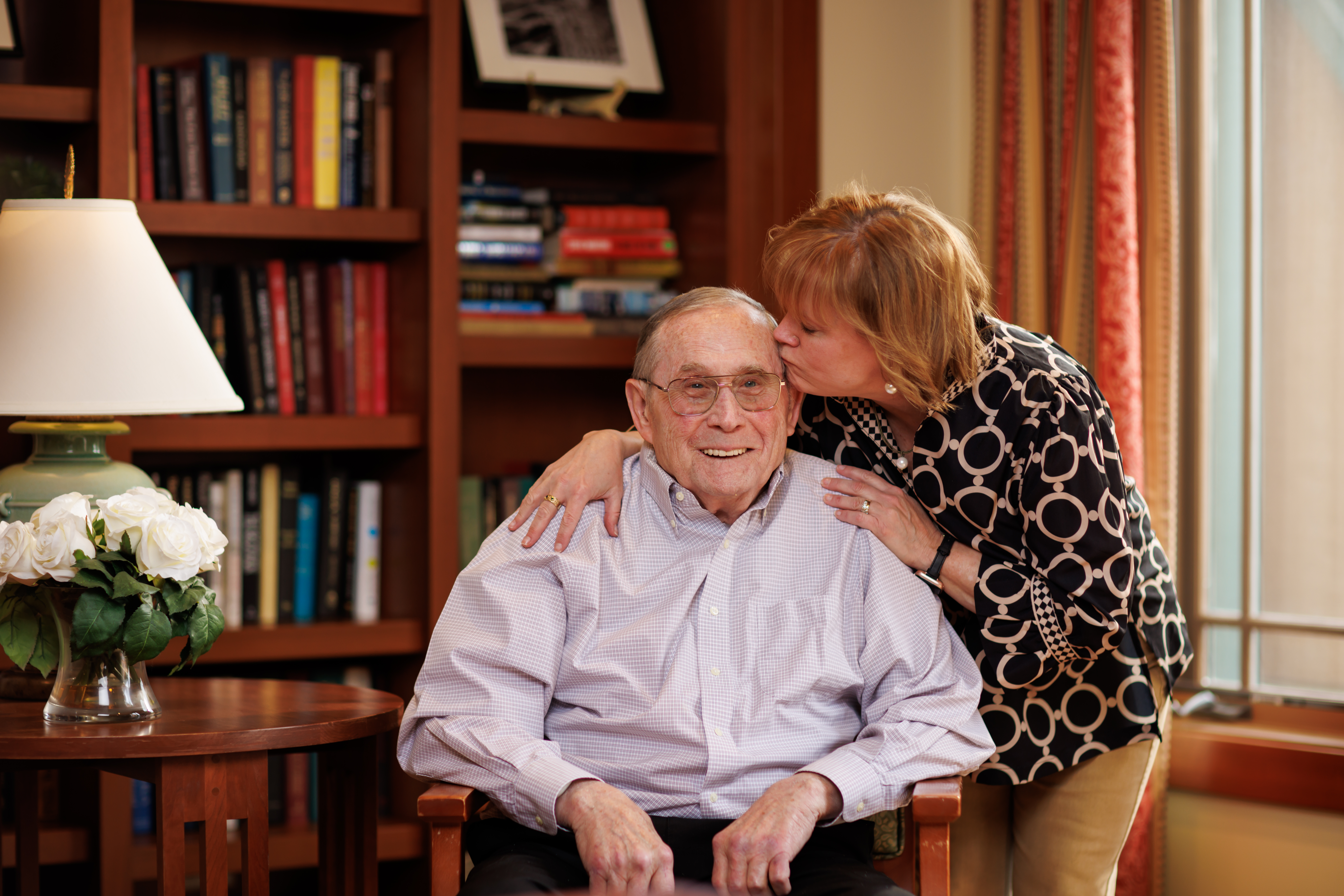 adult daughter kissing her father