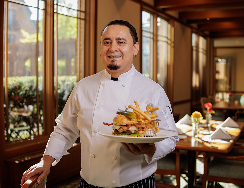 Chef serving a burger at The Winslow
